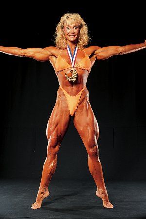 female body builder cory everson Mrs Olympia poses with award